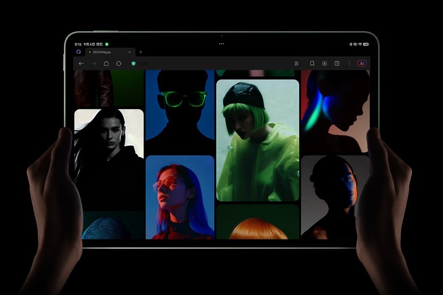 Two hands holding the Xiaomi Pad 9 in landscape, the screen showing a gallery of portraits